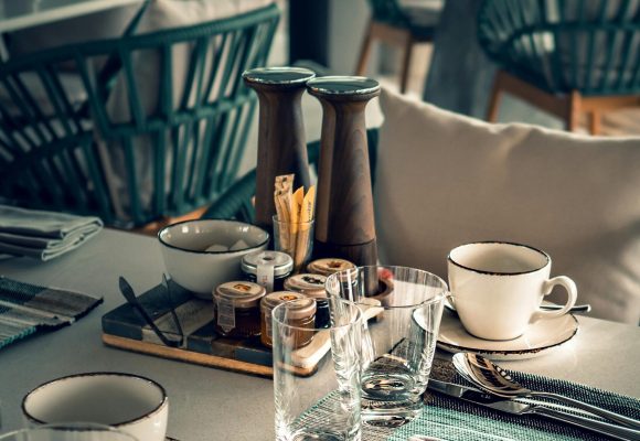 From above of restaurant table set with glassware and silverware before lunch time